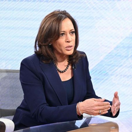 Kamala Harris in a black suit poses for a picture.
